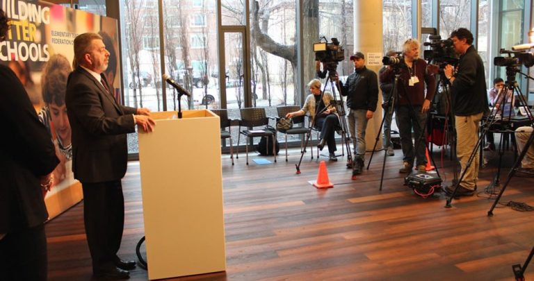 President Sam Hammond at the podium with reporters at a press conference at the ETFO office