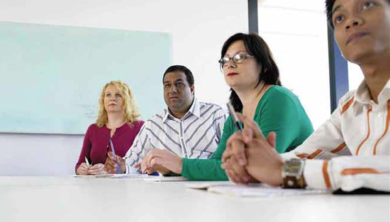 people at table with notepads